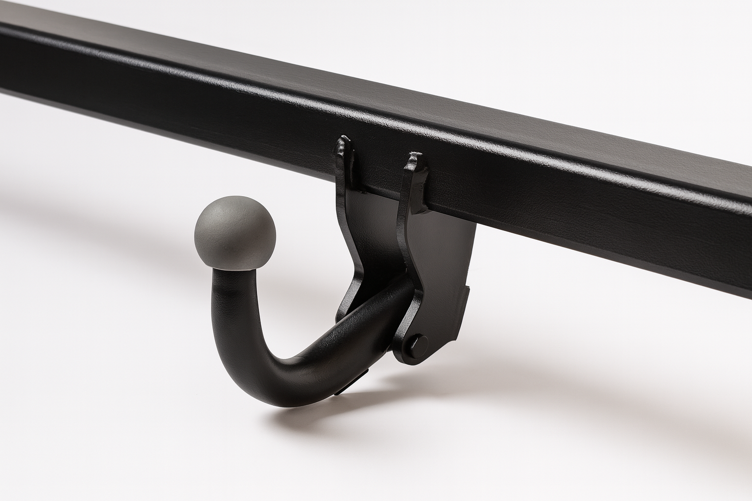 Schwarze Anhängerkupplung mit grauem kugelförmigem Abschluss auf weißem Hintergrund